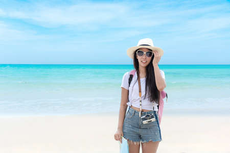 Happy traveler and tourism young women travel summer on the beach.Â  Asian  people holding map and camera take photo  and relax outdoor for destination and leisure trip travel in holiday.Â  Summer Travelの写真素材