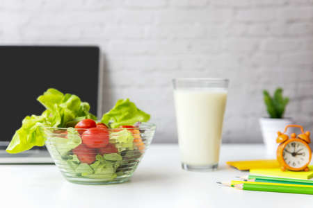 Healthy snack with working in office.  Green apple and fresh water for diet Health Planning, laptop work background.  Healthy Lifestyle Conceptの写真素材