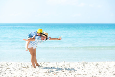 Asia happy family have fun fly on the beach for leisure and destination.  Family people father and girl tourism travel enjoy in summer and holiday, copy space and banner. Travel and Family Conceptの写真素材