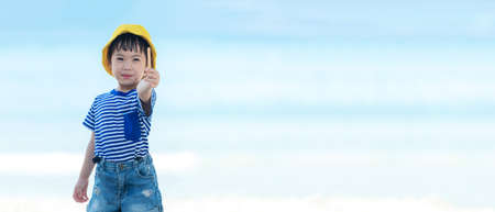 Kid girl have fun and playing sand and water at tropical beach. Family child tourism travel enjoy...