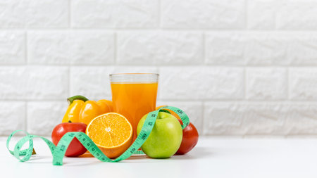 Select focus. Diet and healthy fresh fruits vegetable for detox body slim fit for health lifestyle with orange juice,  white background. Weight Loss and Diet Concept, copy space for bannerの写真素材
