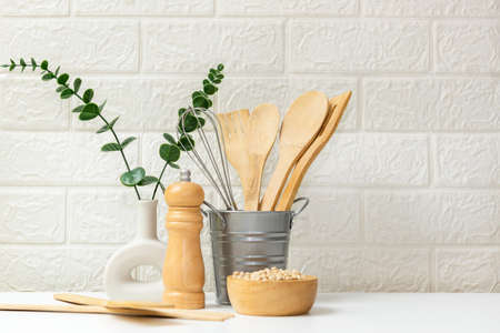 Kitchen tools and kitchenware utensil object on kitchen shelf wood white for healthy eat and health care life.  Wall white brick background, copy space for textの写真素材