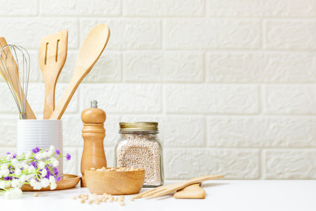 Kitchen tools and kitchenware utensil object with ingredients and mix nut on kitchen shelf wood white for healthy eat and health care life.  Wall white brick background, copy space for textの写真素材