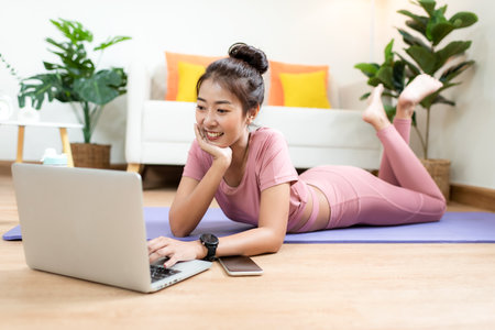 Healthy lifestyle young woman fitness gym for body slim. Young people girl exercise at living room on line. Fitness instructor exercising the fitness. Diet and Healthy sport Conceptの写真素材