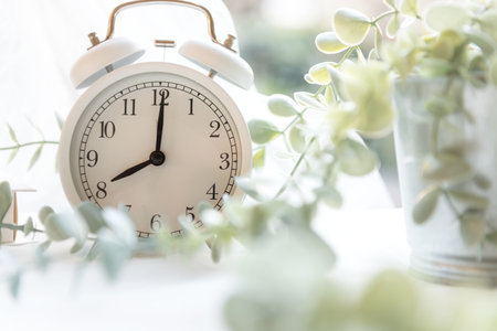 Early Work day.  Alarm clock on bed in morning with sun light,  copy space and banner for tex.  Morning and Start up Conceptの写真素材