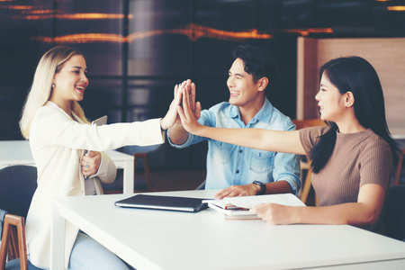 Teamwork Solidarity Success. Young people hands executive business group team happy showing teamwork and joining hands after meeting and leaning partner business in class roomの写真素材