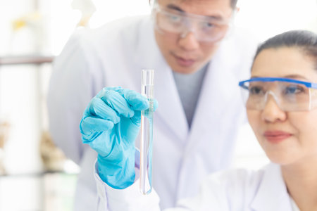 Close up hand scientists study cell health care and researchers doing some research with dropper chemical testing and working in life science laboratoryの写真素材