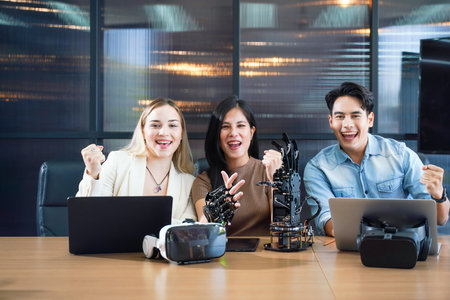 Group team work programer and engineer working AI robot arm system.  Business people Start-up production process technology and logic control constructing arm system projectの写真素材