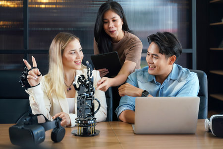 Group team work programer and engineer working AI robot arm system.  Business people Start-up production process technology and logic control constructing arm system projectの写真素材