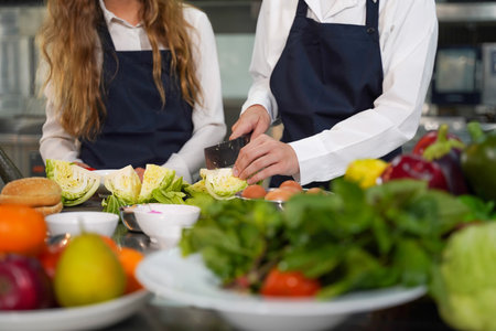 Close up hand Chef the group children cut vegetables in class kitchen room.  Chef preparing student for learning marking and cooking food at workshop.  Education Conceptの写真素材