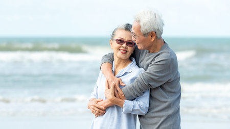 Asian Lifestyle senior couple hug on the beach happy in love romantic and relax time.Â  People tourism elderly family travel leisure and activity after retirement in vacations and summerの写真素材
