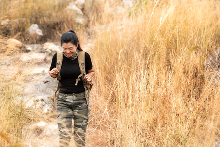 Hiker asian woman backpack walking trail activity camping outdoors for destination leisure.  People exploring forest green natural capturingÂ beauty nature outdoor.Â Traveler Vacations Conceptの写真素材