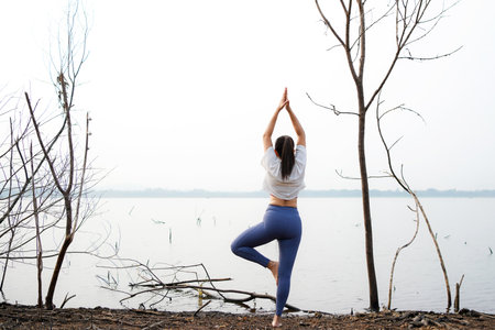 Lifestyle woman yoga exercise and pose for healthy life.Â  Young girl or people pose balance body vital zen and meditation for workout and fitness sport outdoor. Health care Conceptの写真素材