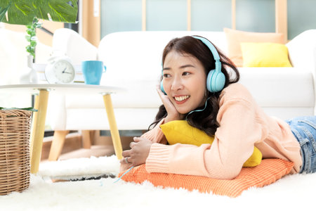 Lifestyle woman relaxing sleeping in living room. Happy girl lying down on comfortable pillows taking a nap for wellness and health in weekend holiday.  Lifestyle Conceptの写真素材