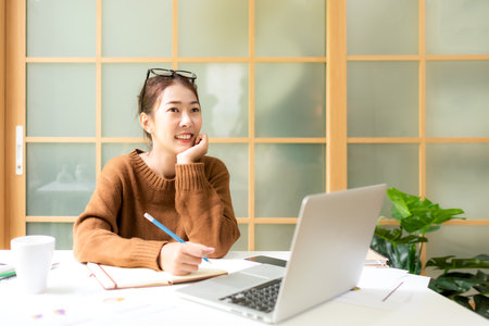 Young people work from home using smartphone connection for meeting with office.  Asia woman meeting conference connect online with office.  Business and Technology Conceptの写真素材