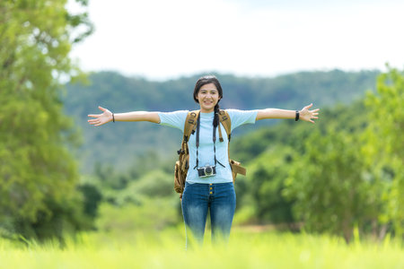 Young people woman traveler and tourism raise arms trips travel on hatchback car to destination leisure travel on forest in holiday vacations.  Happy and Enjoy trip adventure.  Travel Conceptの写真素材