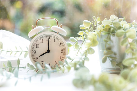Early Work day.  Alarm clock on bed in morning with sun light,  copy space and banner for tex.  Morning and Start up Conceptの写真素材