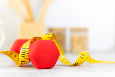 Close up dumbbell and tape measure.  Healthy snack for diet planning.  Kitchen item background.  Healthy Lifestyle Conceptの写真素材