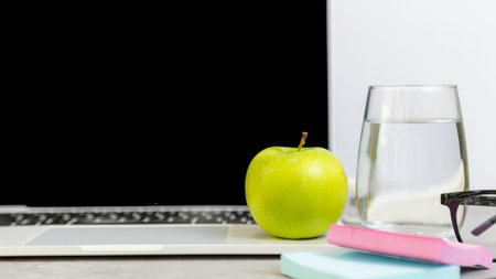Healthy snack with working in office.  Green apple and fresh water for diet Health Plan with laptop on white dress working.  Healthy Lifestyle Conceptの写真素材