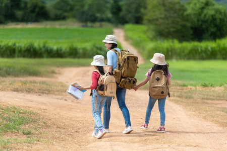 Group family children checking map in the jungle adventure.   Asia people tourism for destination leisure trips for education and relax in nature park.  Mountain background.  Travel vacations and Life Conceptの写真素材
