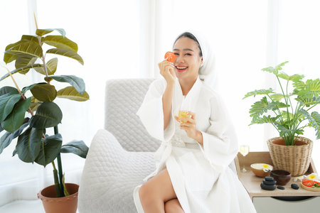 Asia women relaxing enjoy and spa massage with facial masks  tomato put on bathrobe.  Spa beauty massage healthy wellness.  Spa Thai therapy treatment aromatherapy for body womanの写真素材