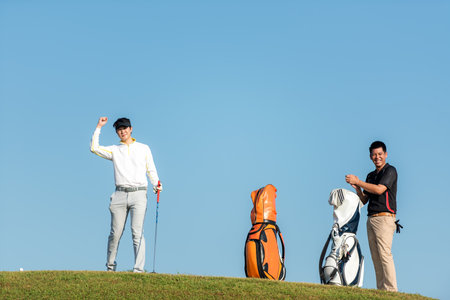 Golfer sport course golf ball fairway.Â   Group People lifestyle man and friend playing game golf tee off on the green grass.Â  Asia men player game shot in summerの写真素材