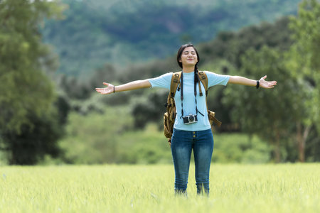 Young people woman traveler and tourism raise arms trips travel on hatchback car to destination leisure travel the road forest in holiday vacations.  Happy and Enjoy trip adventureの写真素材
