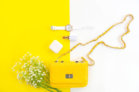 Fashion stylish yellow bag and woman accessories pastel background. Trendy fashion luxury handbag, perfume and cosmetic design. Lifestyle and Beauty Conceptの写真素材