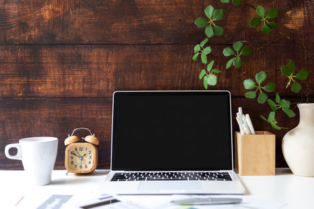 Business workplace with laptop and graphs finance diagrams and coffee drink. Old wood background.  Business Object Conceptの写真素材