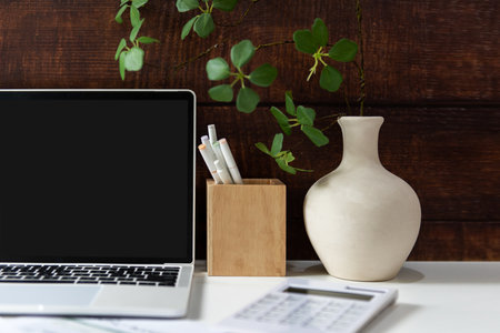 Business workplace with laptop and graphs finance diagrams and coffee drink. Old wood background.  Business Object Conceptの写真素材