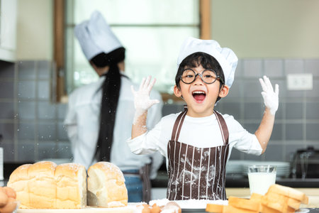 Lifestyle Family. Chef asian mother and kid boy cooking toast and make  bread for dinner.  Asian son help mom making sweet food, so happy and enjoy.  Family Conceptの写真素材