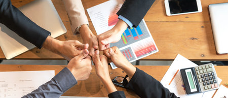 Teamwork Solidarity Success. Close up hands executive business people group team happy showing...