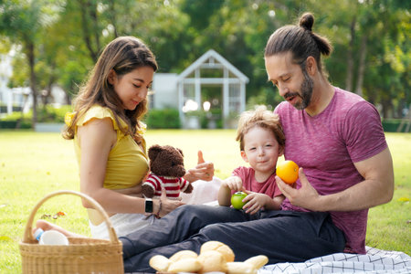 Happy family picnic in the park public on summer holiday.  Family relax and enjoying outdoor.  Family and Lifestyle Conceptの写真素材