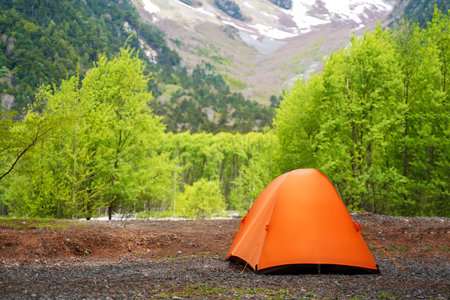Camping tent outdoor. Camping leisure and destination travel near green forest mountain snow winter on the tents in morning. Tourism relax and chill in summer holiday.の写真素材