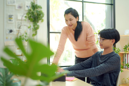 Asian women teacher tutor teenage man for distance education and doing homework online.Â Education Conceptの写真素材
