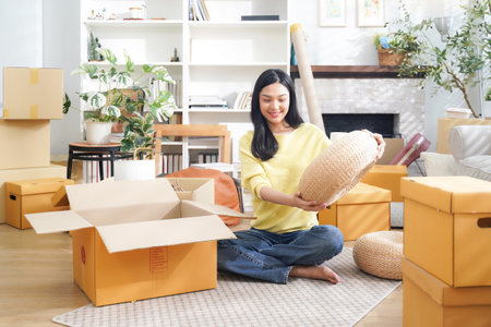 Young women moving home while packing boxes together and happy in new home.Â  Asia women investment real estate for living with family.Â Â  Investment and Family Conceptの写真素材