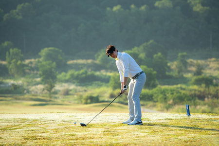 Golfer sport course golf ball fairway.Â  People lifestyle man approach playing game golf tee off on the green grass.Â  Asian man player game shot in summer.Â  Healthy and Sportの写真素材