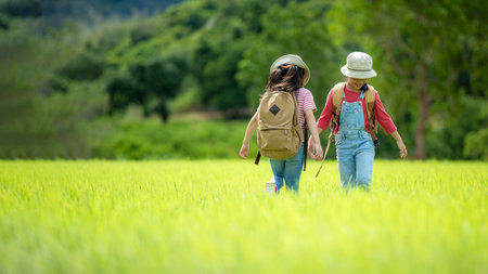 Group family children checking map in the jungle adventure.   Asia people tourism for destination leisure trips for education and relax in nature park.  Mountain backgroundの写真素材
