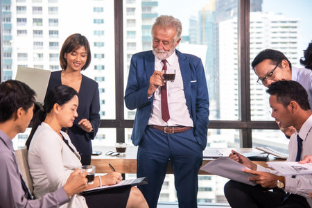 Senior Businessman and teamwork meeting and discussing report at meeting room. Boss man and business consulting people training work and talkingの写真素材