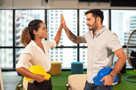Business engineer partner woman and businessman joining and stack hand together for start up new Project outdoor modern office. City background.  Teamwork and Business Conceptの写真素材
