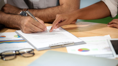Man hand signing a contract on document for building house economic with architect and partner. select focus. Contract Conceptの写真素材