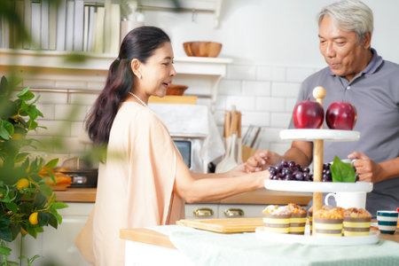 Asia happy senior elderly couple relax at kitchen room.Â Â  Senior couple happy cooking food and cake at home after retirement.Â  Family Conceptの写真素材
