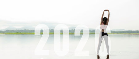 Happy new year start up 2026.  Yoga women lifestyle exercise and pose for healthy life. people balance body vital zen and meditation for workout sunrise morning nature backgroundの写真素材