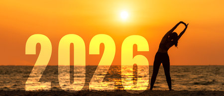 Happy new year card 2026. Silhouette lifestyle woman yoga raise arm standing as part of Number 2026 near the beach at sunset. Healthy and Holiday Conceptの写真素材
