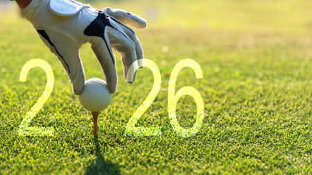 Close up hand Golfer woman putting golf ball for Happy New Year 2026 on the green golf for new healthy. copy space. Healthy and Holiday Conceptの写真素材