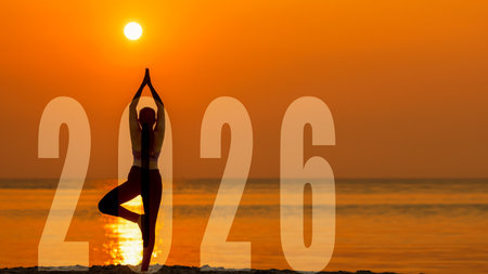 Silhouette lifestyle woman yoga practicing yoga standing as part of Number 2026 near the beach at...