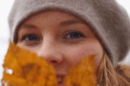 Autumns - Closeup of a cute young woman looking at you の写真素材