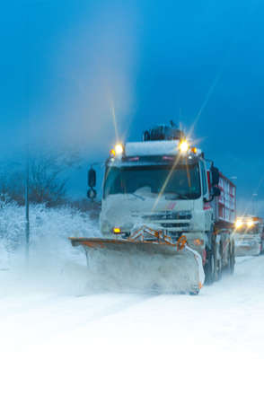 Winter safety - Trucks clearing the snow with their snow plowsの写真素材