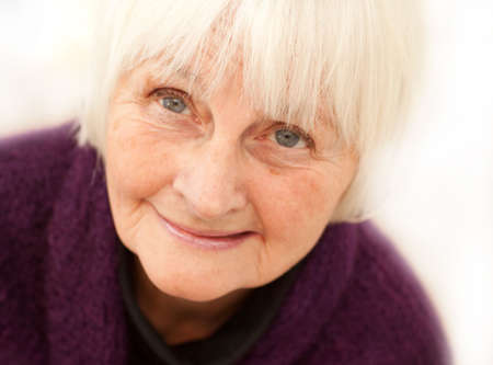 Freindly older mature woman on white background  - looking up at your