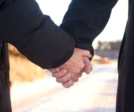 Romance - Old couple holding hands together out for a walk